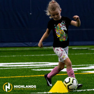 Girl running with soccer ball