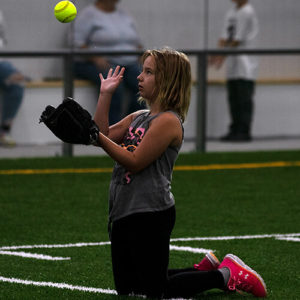 Girl about to catch a soft ball