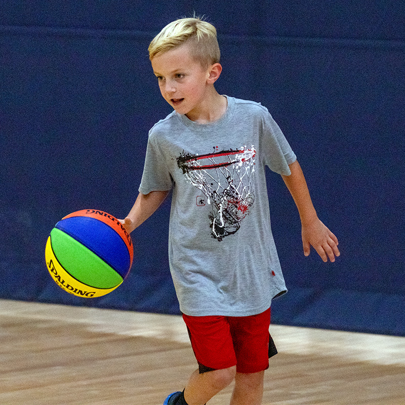 Boy dibbling the basketball